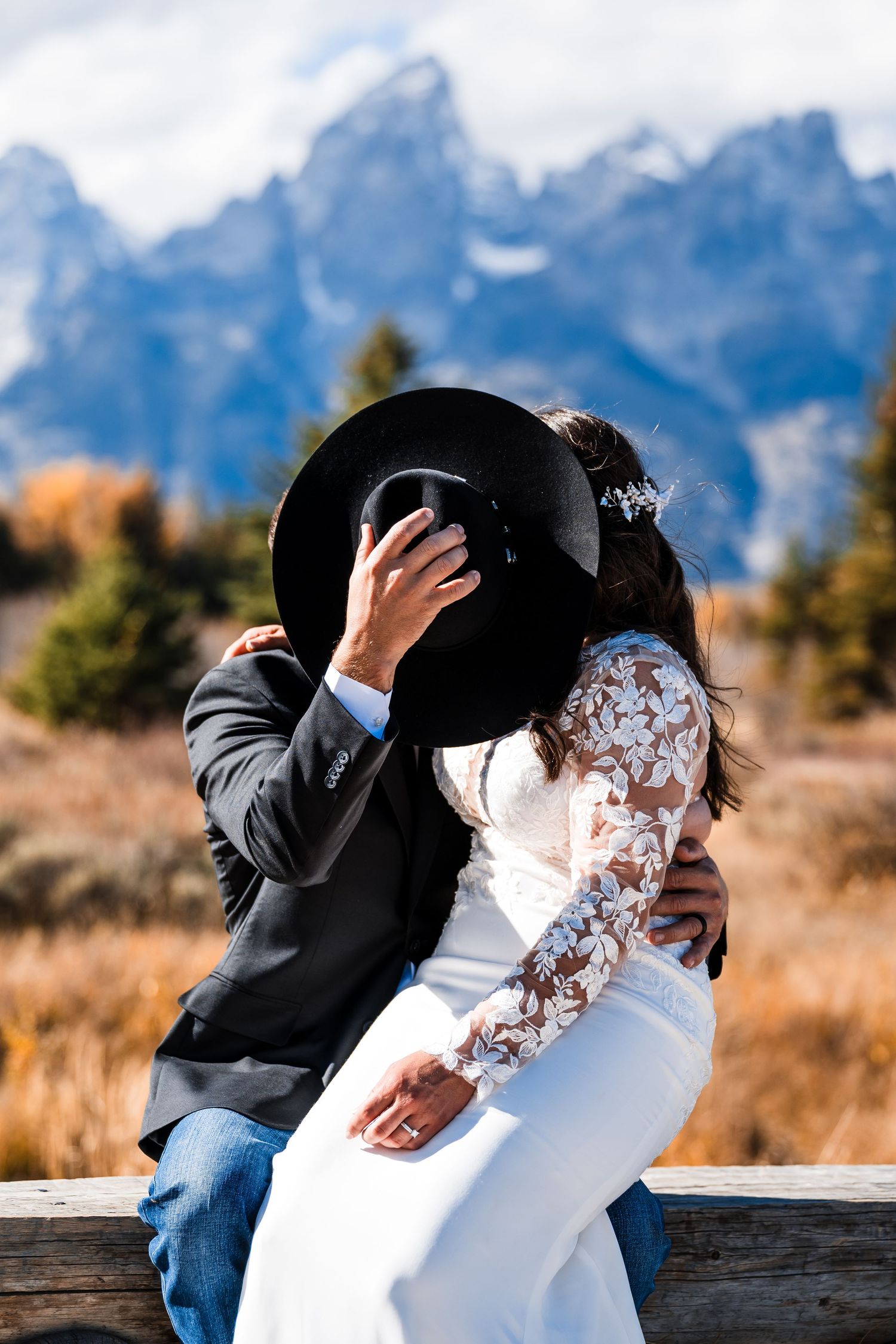 Intimate wedding moment captured against the dramatic backdrop of the Teton mountain range.