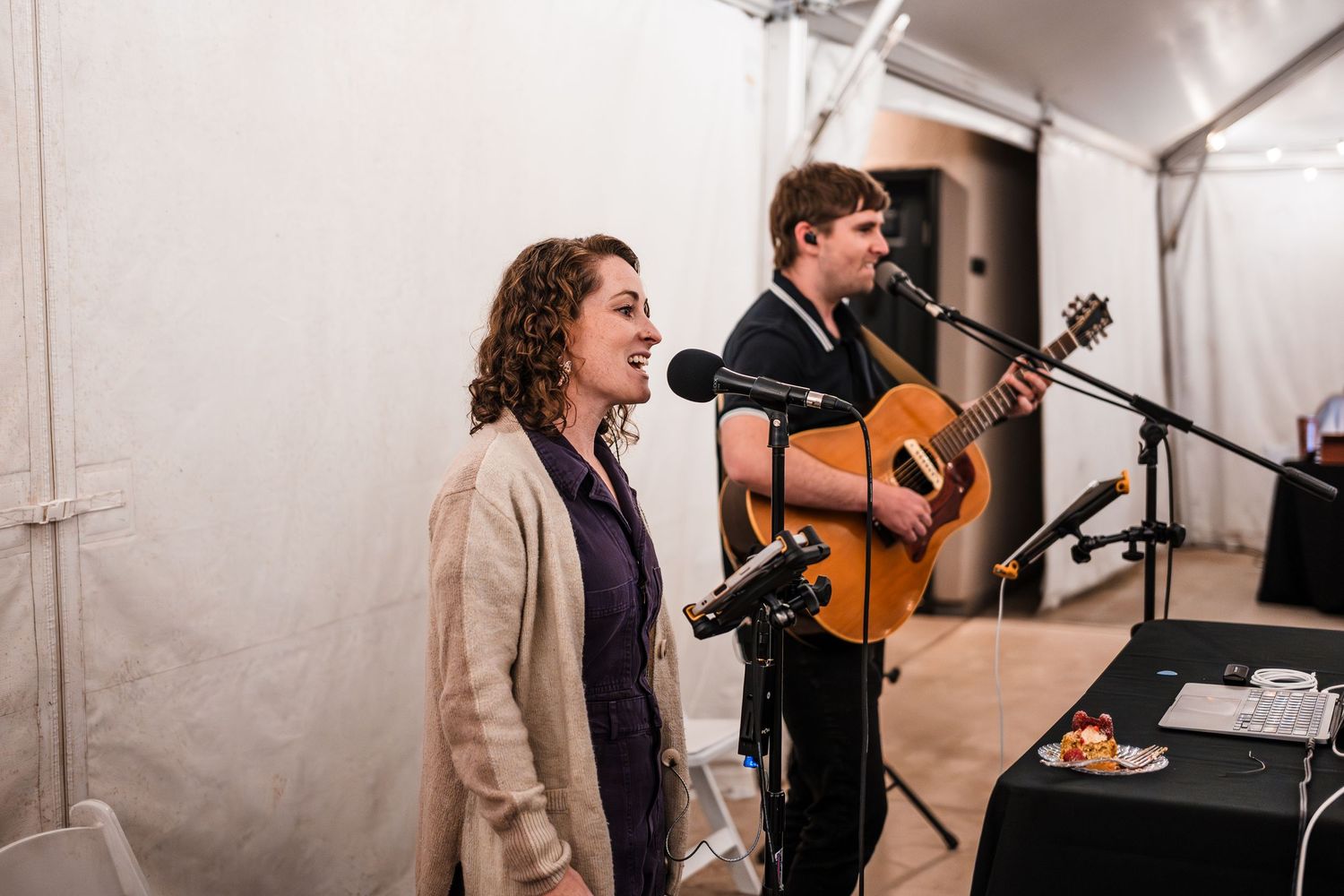 Musicians performing at a wedding ceremony with acoustic instruments and microphones.