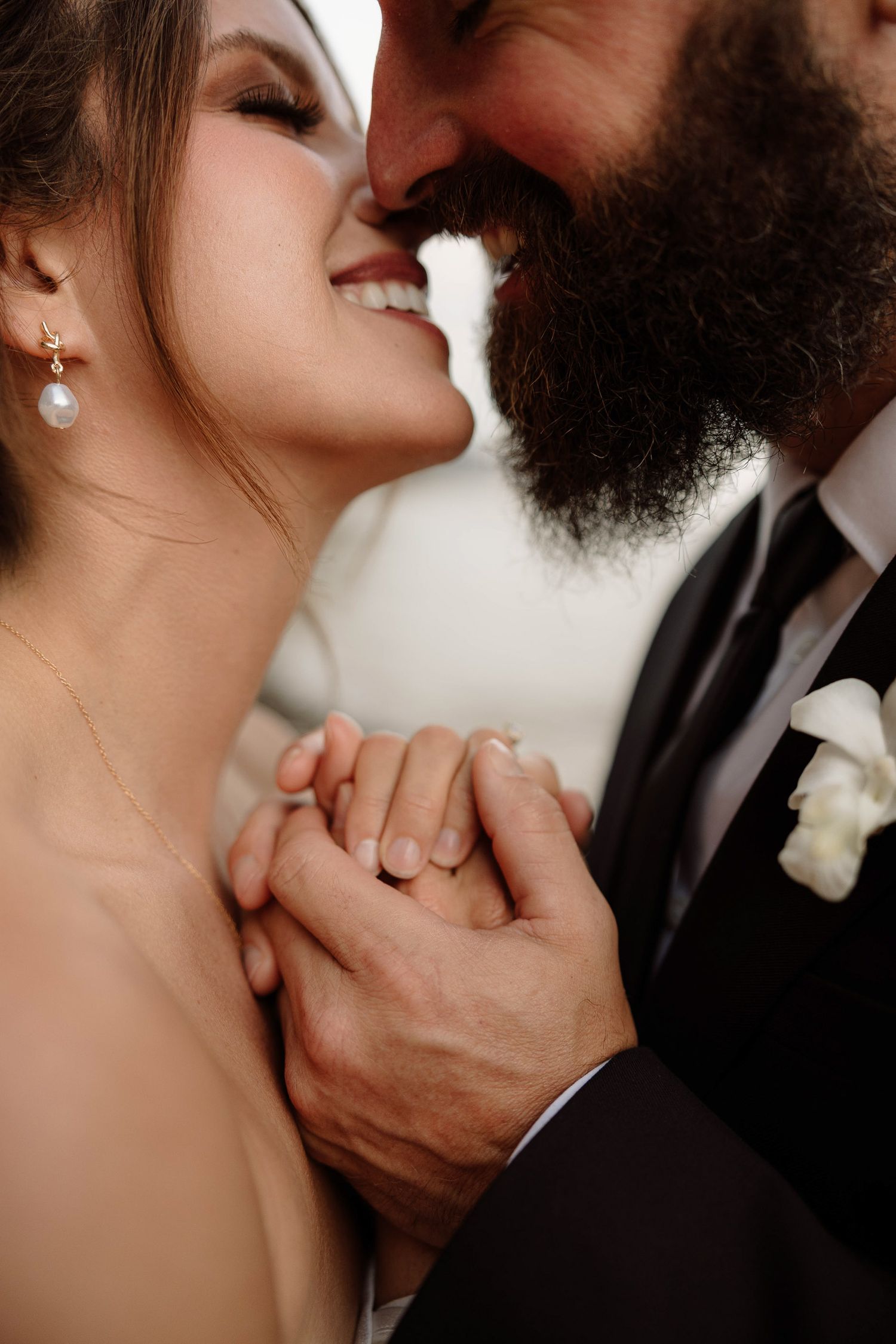 Bride and groom sharing kiss after their elopement on the Na Pali coast in Kauai, Hawaii.