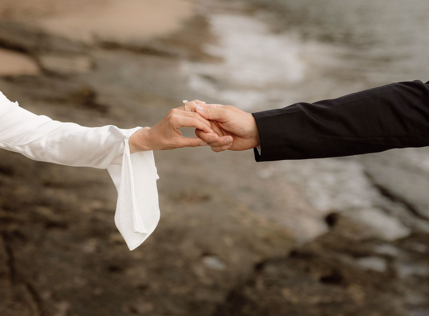 Bride and groom hold hands after their elopement on the Na Pali coast in Kauai, Hawaii.
