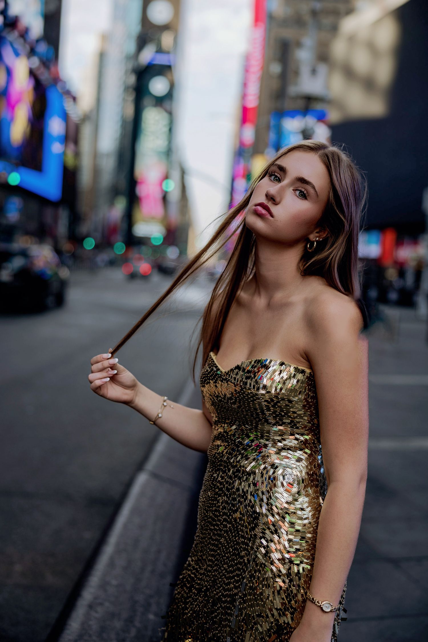 High School Senior posing in a gold gown in Times Square in New York City