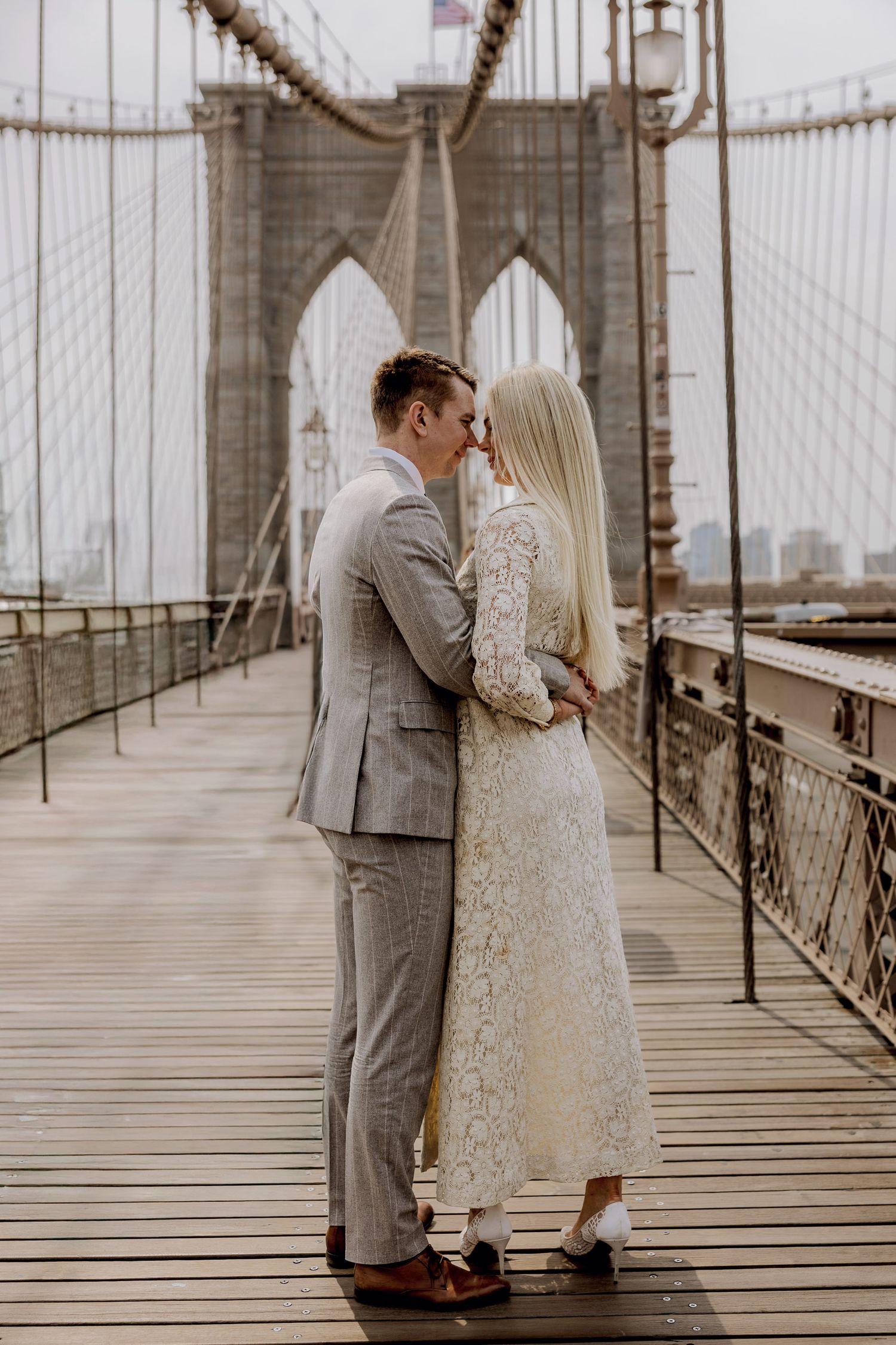 Bride and Groom on the Brooklyn bridge after their elopement in New York City with the skyline in the background.