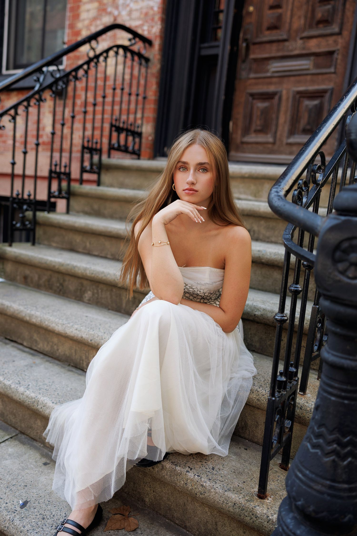 High School senior posing on a stoop in the West Village in New York City.