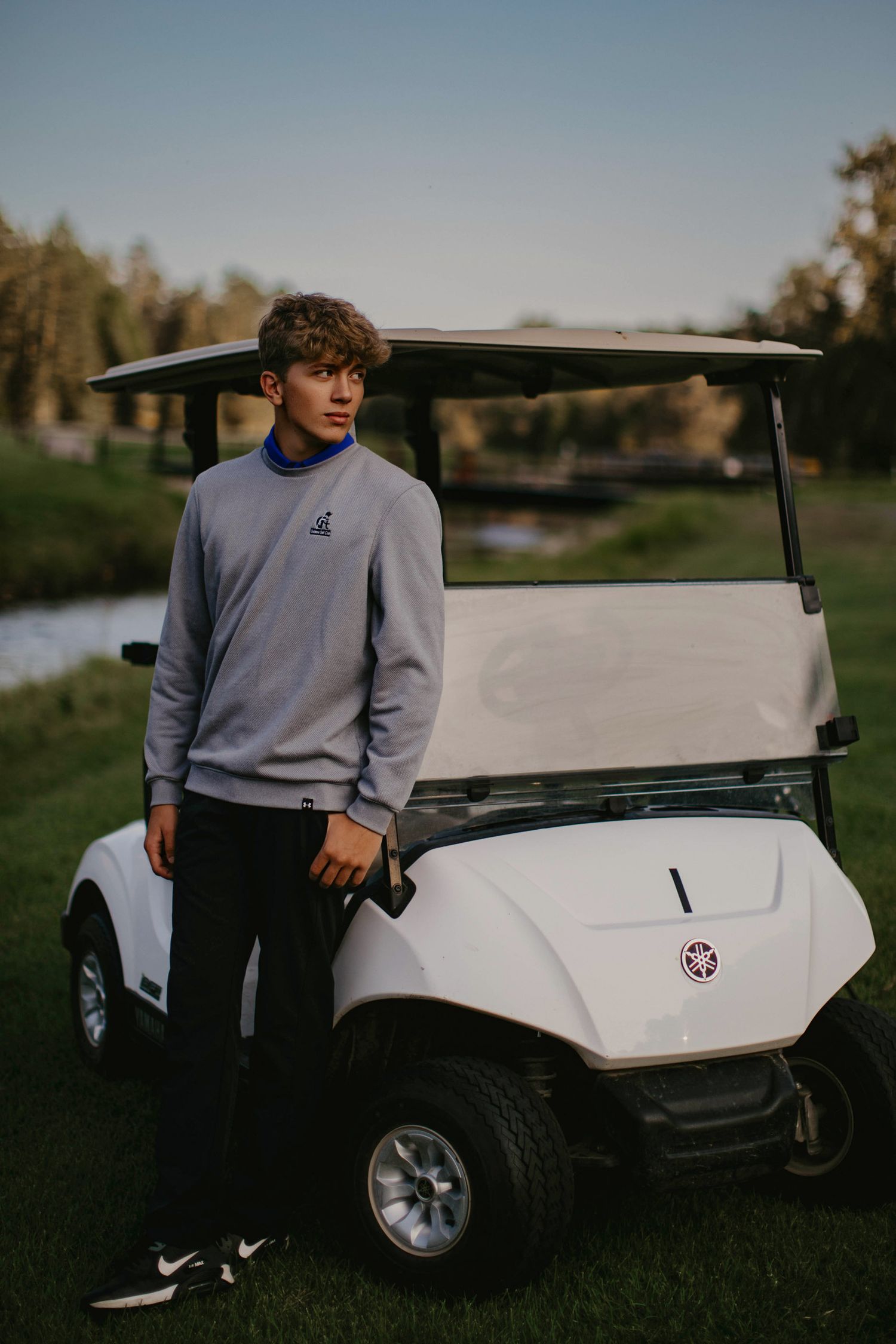 high school senior boy guy portraits golf golf cart, Marquette mi, Escanaba, NYC, Green Bay the best senior photographer