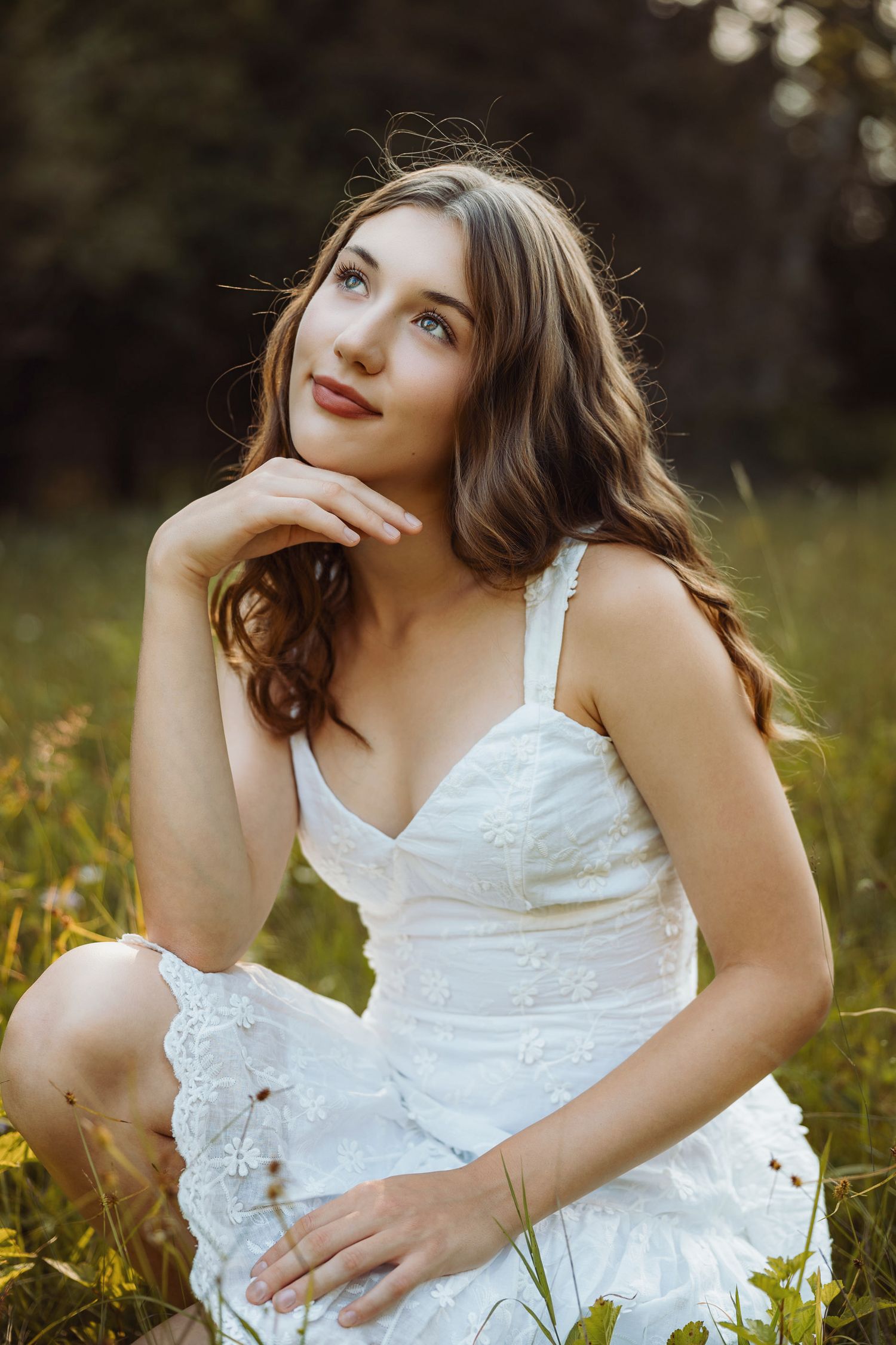 High school senior during golden hour in a field in Marquette, Michigan.