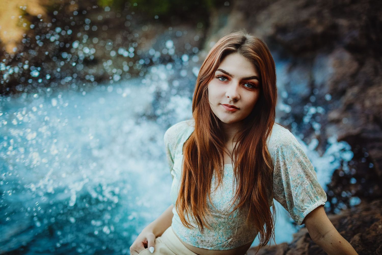 High school senior posing on a beach at Black Rocks on Preque Isle in Marquette, Michigan.