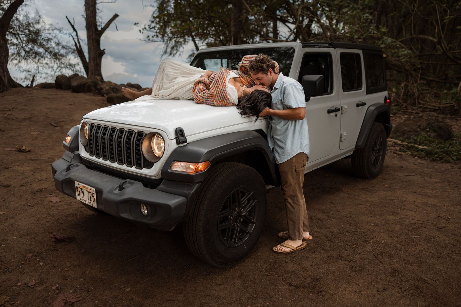 Engagement couple on the beach with a jeep in kauai, Hawaii. Elopement photographer, destination.