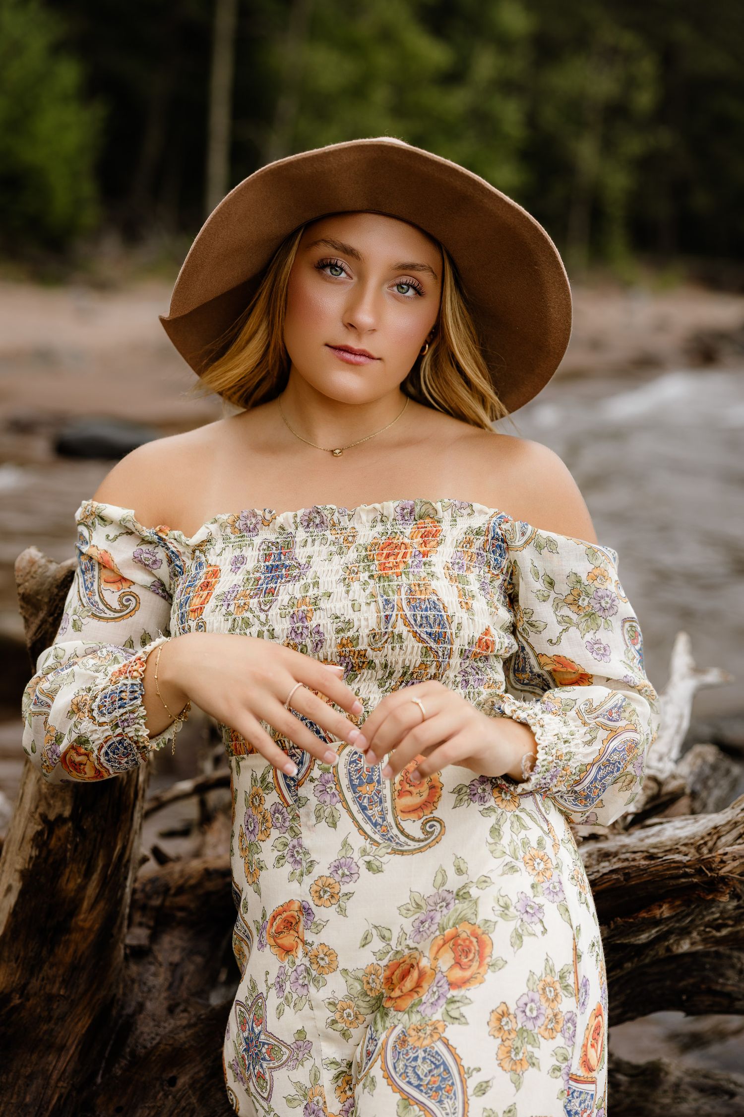 High school senior posing on a beach at Black Rocks on Preque Isle in Marquette, Michigan.