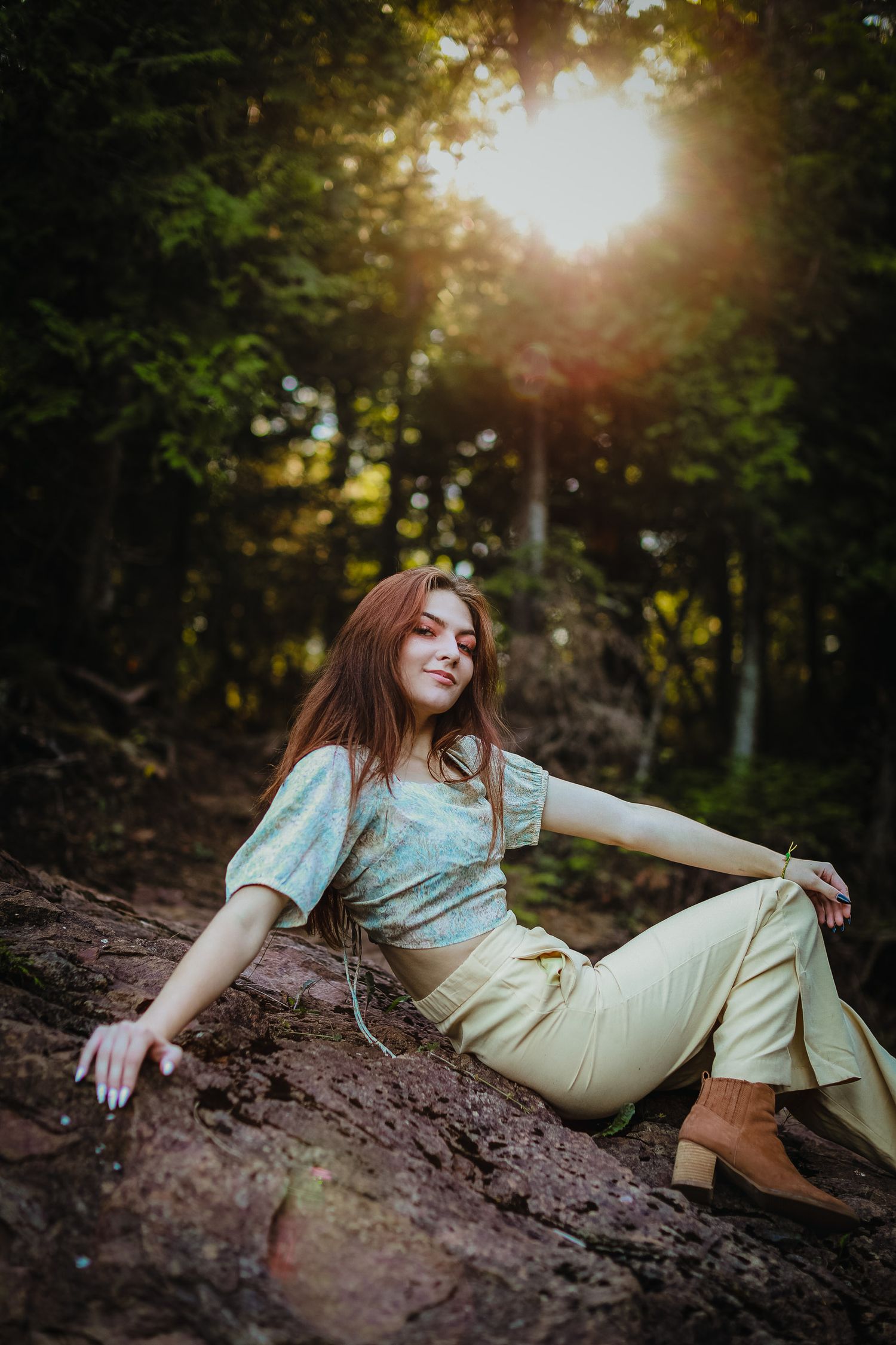 High school senior posing on a beach at Black Rocks on Preque Isle in Marquette, Michigan.