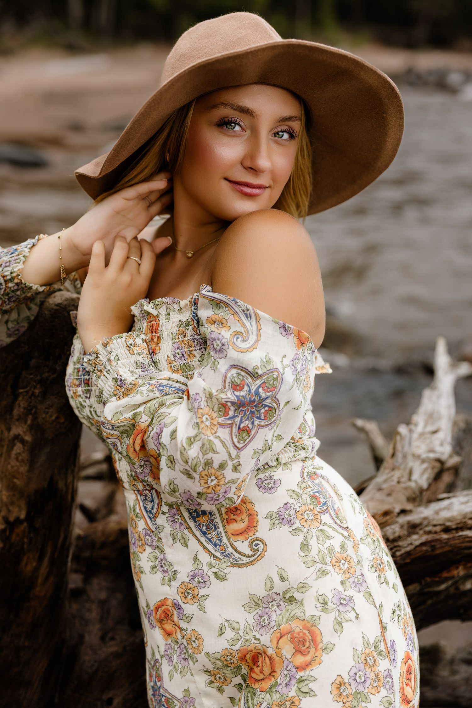 High school senior posing on a beach at Black Rocks on Preque Isle in Marquette, Michigan.