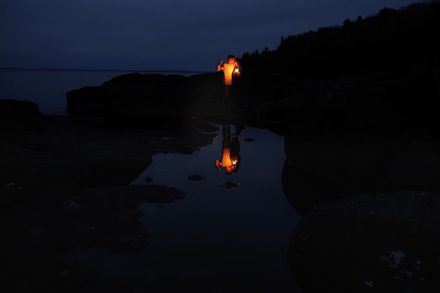 Romantic engagement session with lanterns at nigh at Black Rocks in Marquette, Michigan.
