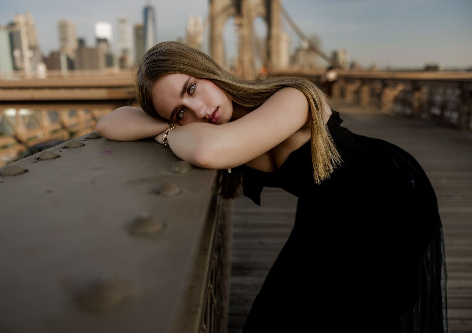 Senior portrait on the Brooklyn Bridge in New York City with the skyline in the background.