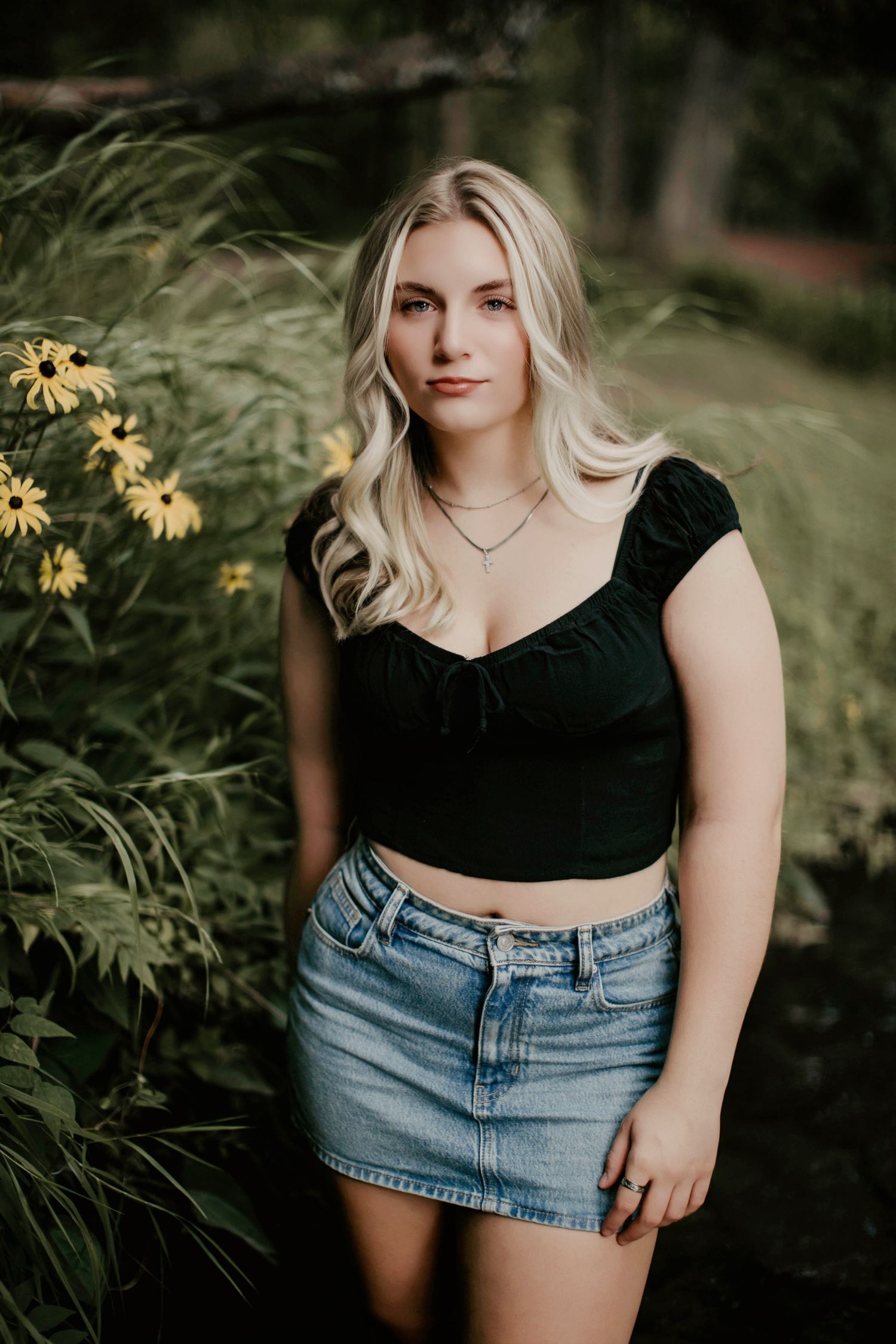 high school senior girl in the water surrounded by flowers. Escanaba, Marquette, NYC best senior portrait photographer