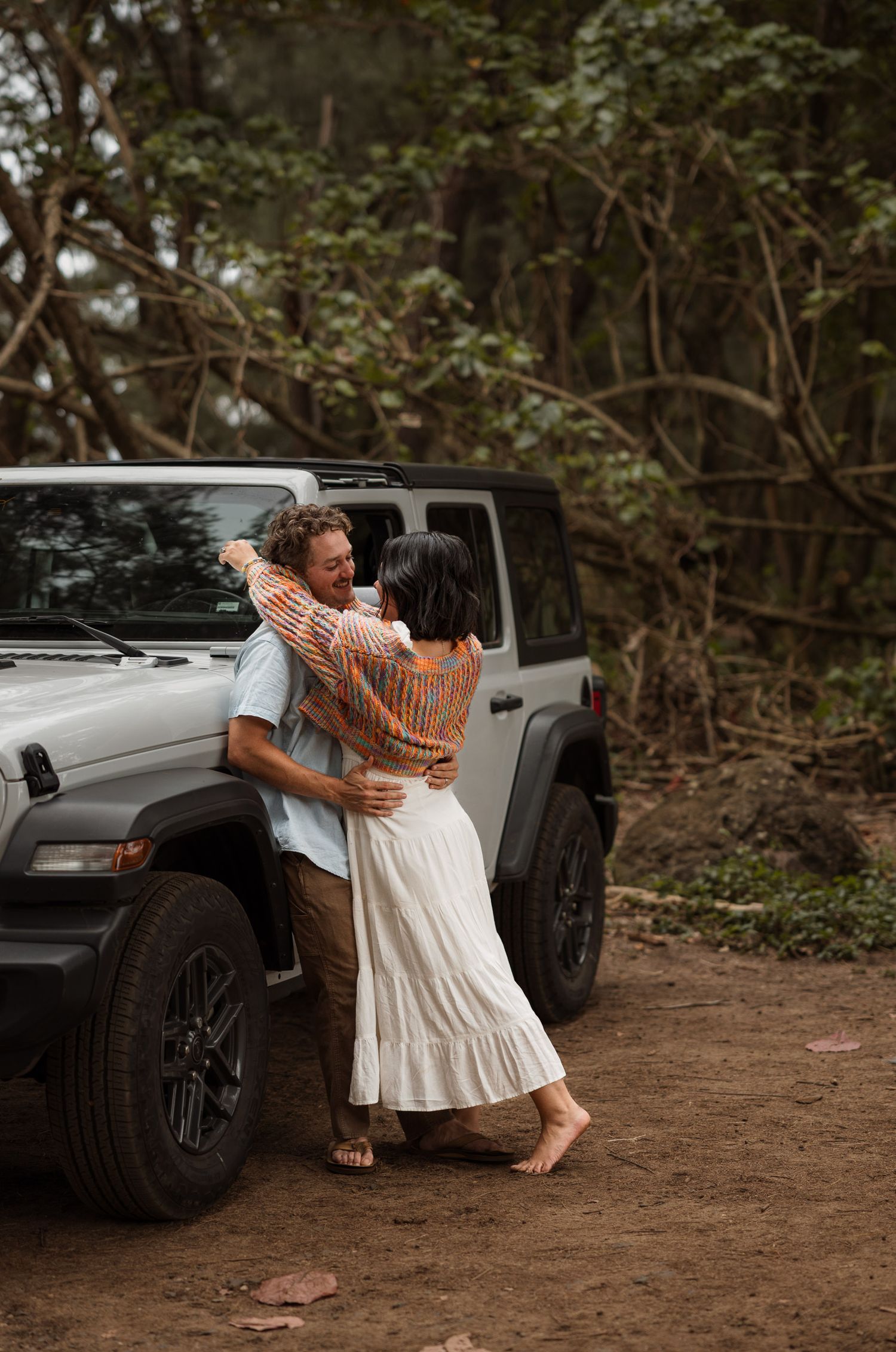 Engagement couple on the beach with a jeep in kauai, Hawaii. Elopement photographer, destination.
