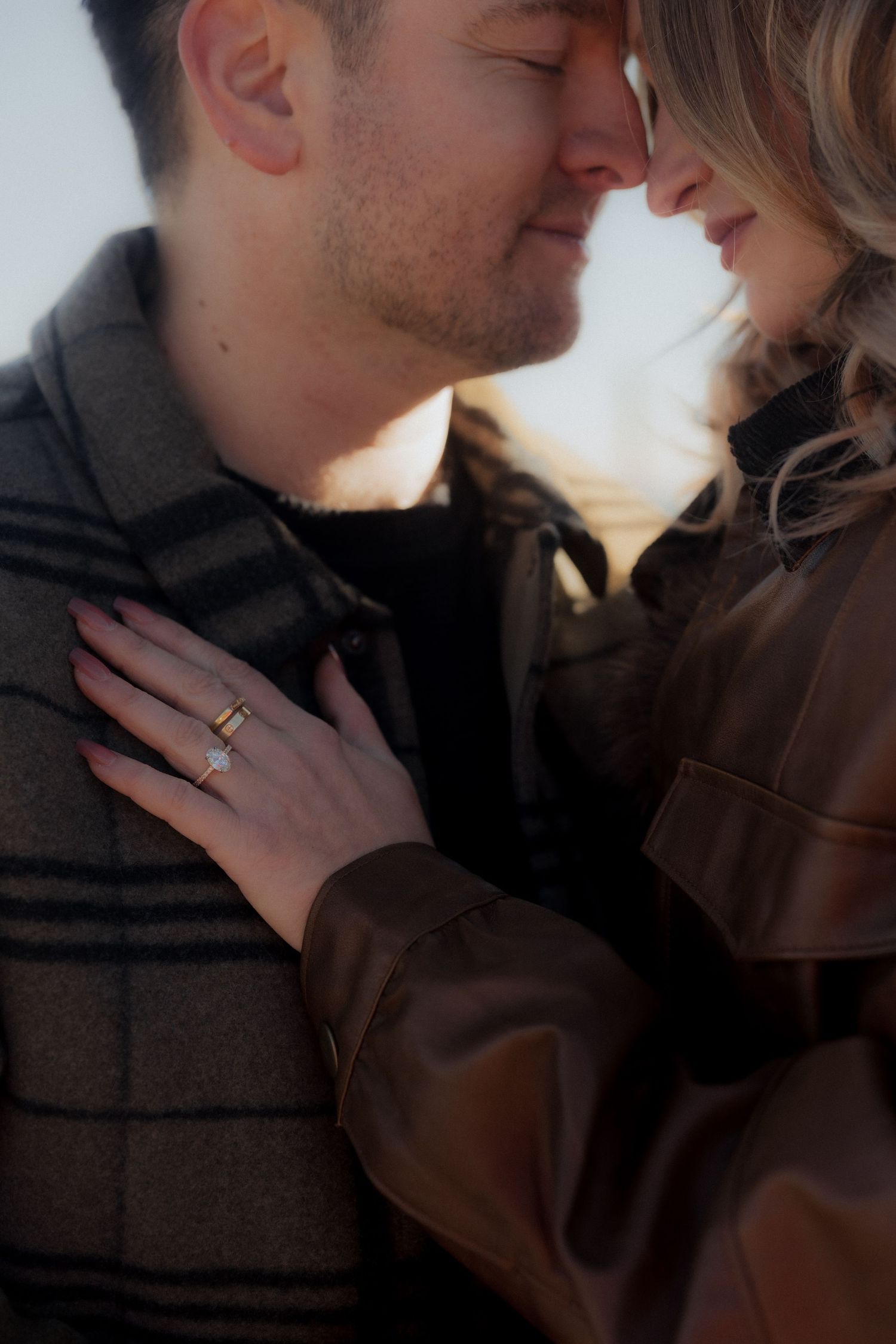 A romantic close-up series of a couple sharing intimate moments together, with hands showing a wedding ring.