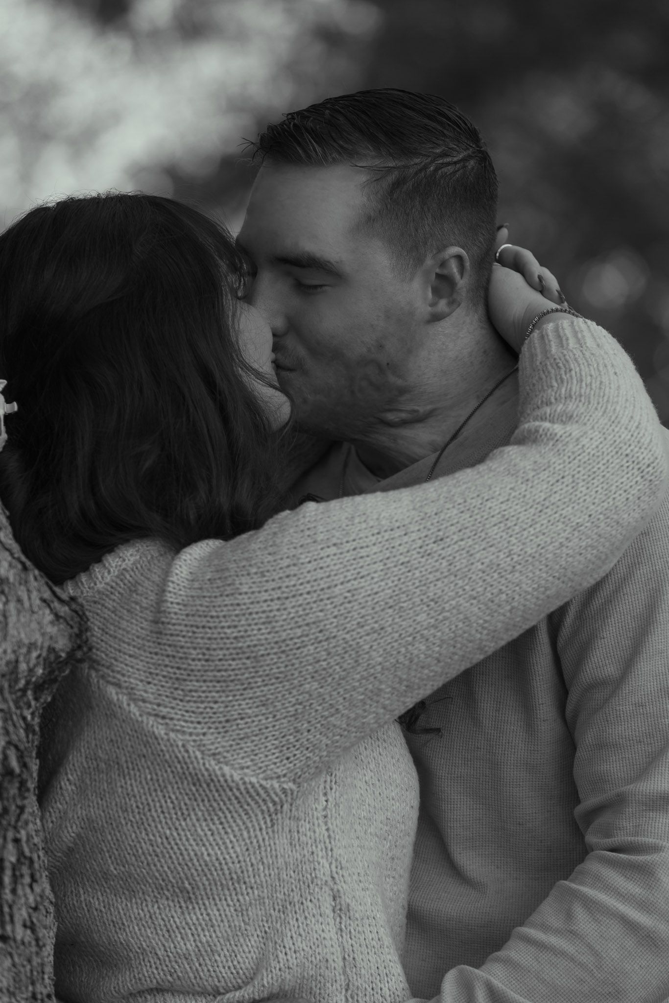 Intimate black and white portrait of couple sharing a tender moment.