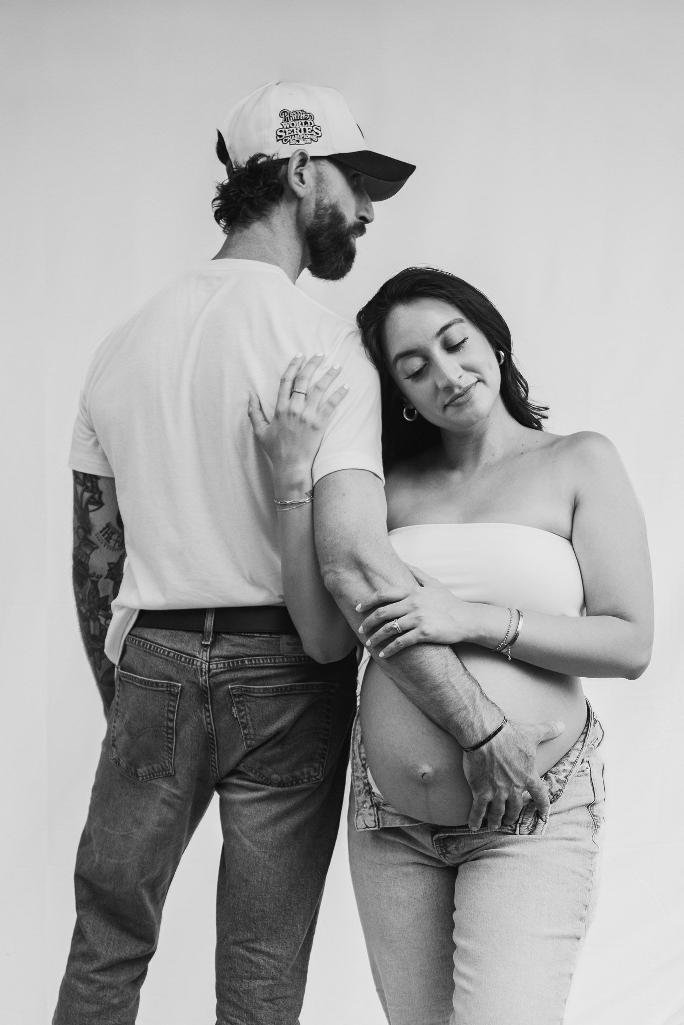 Black and white artistic maternity photos showing intimate moments and gentle embraces.