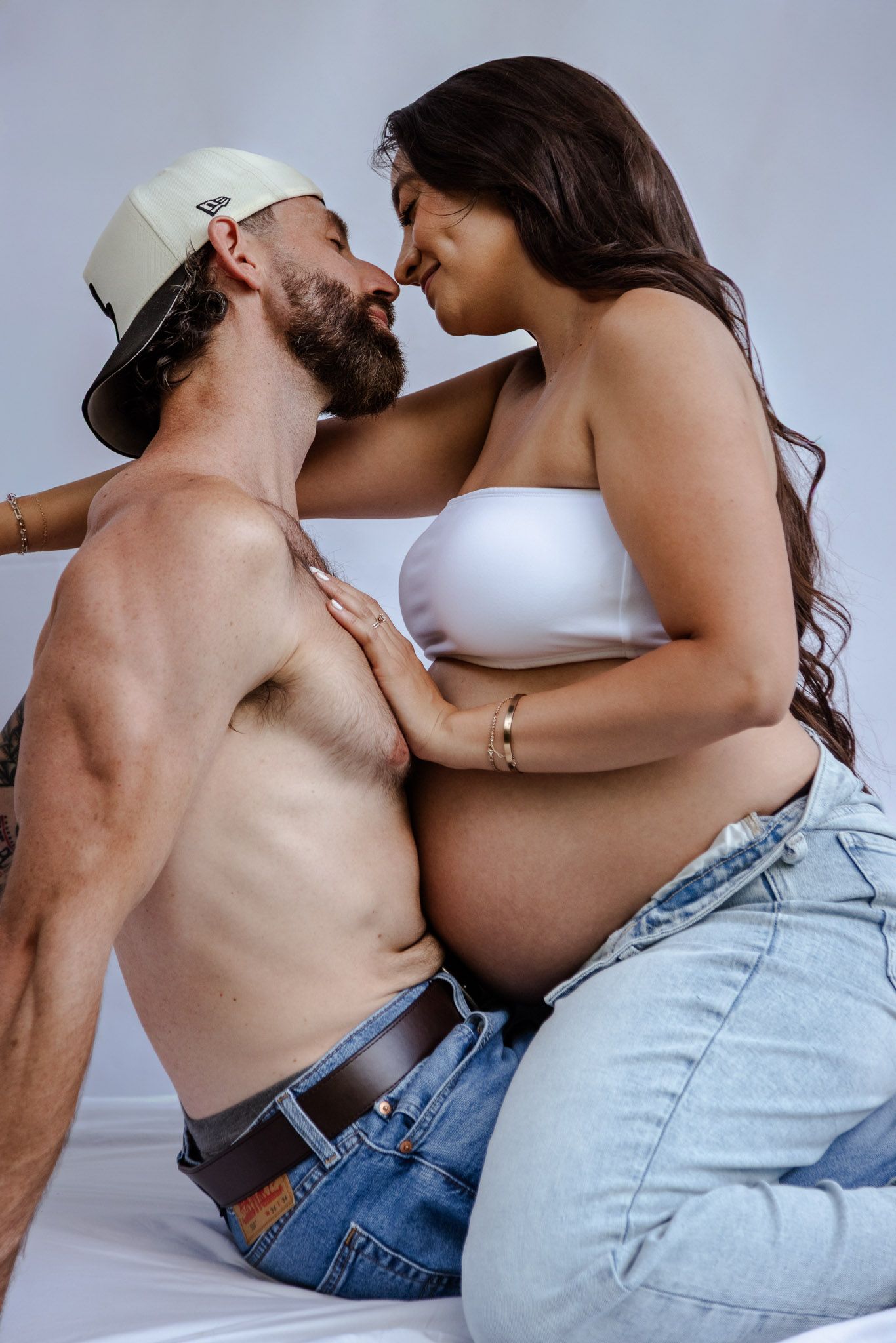 Artistic black and white maternity photos capturing intimate moments between expectant couple.