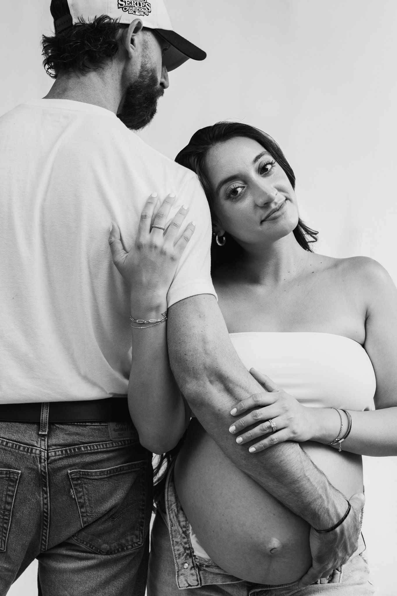 Artistic black and white photo series showing intimate moments between a couple in casual clothing.