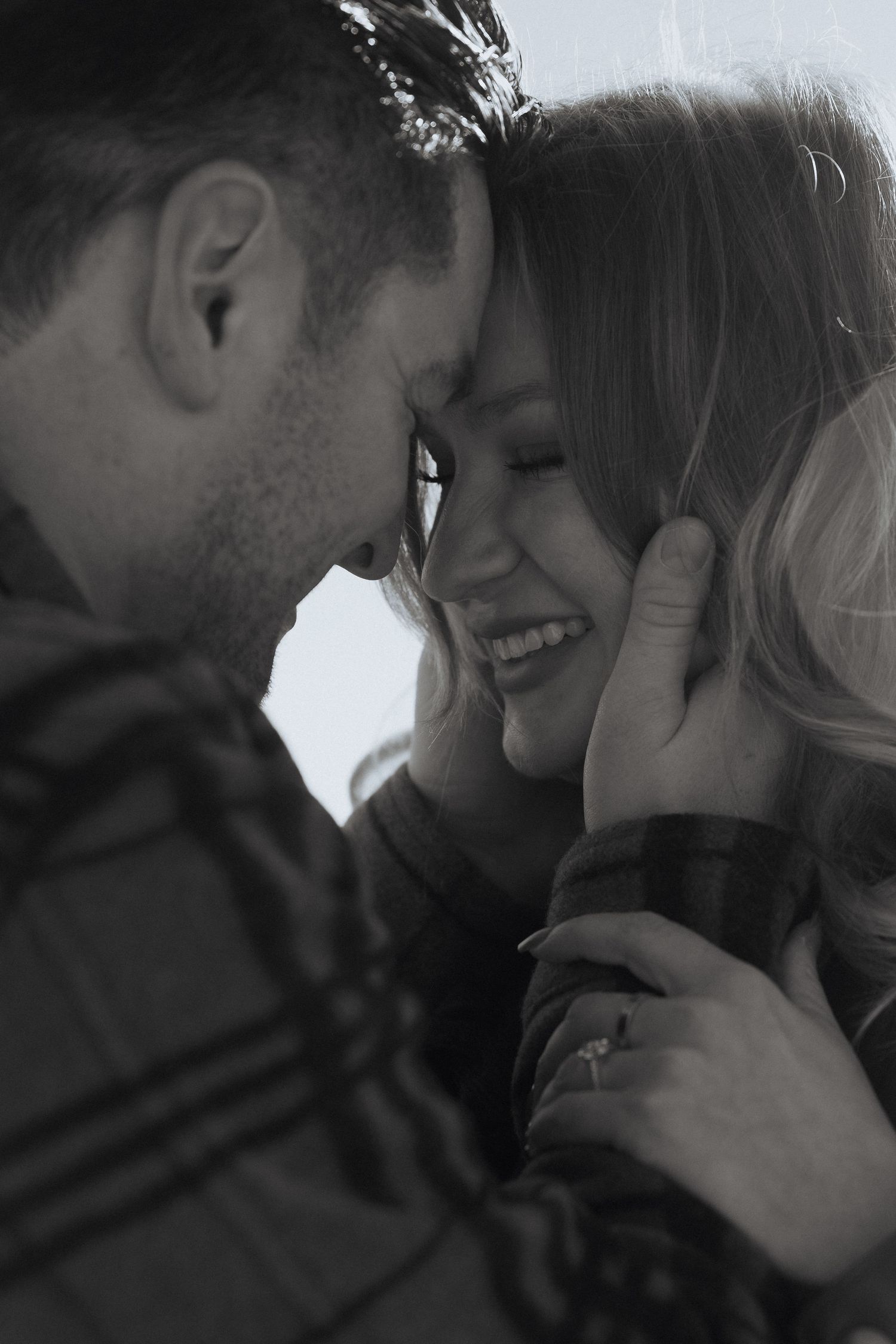 A series of romantic black and white photographs showing intimate moments between a couple in close embrace.