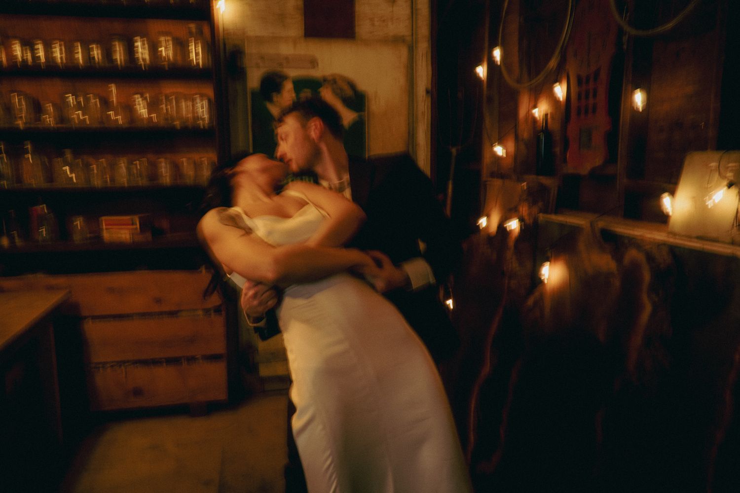 Romantic dance scene at night illuminated by warm string lights.