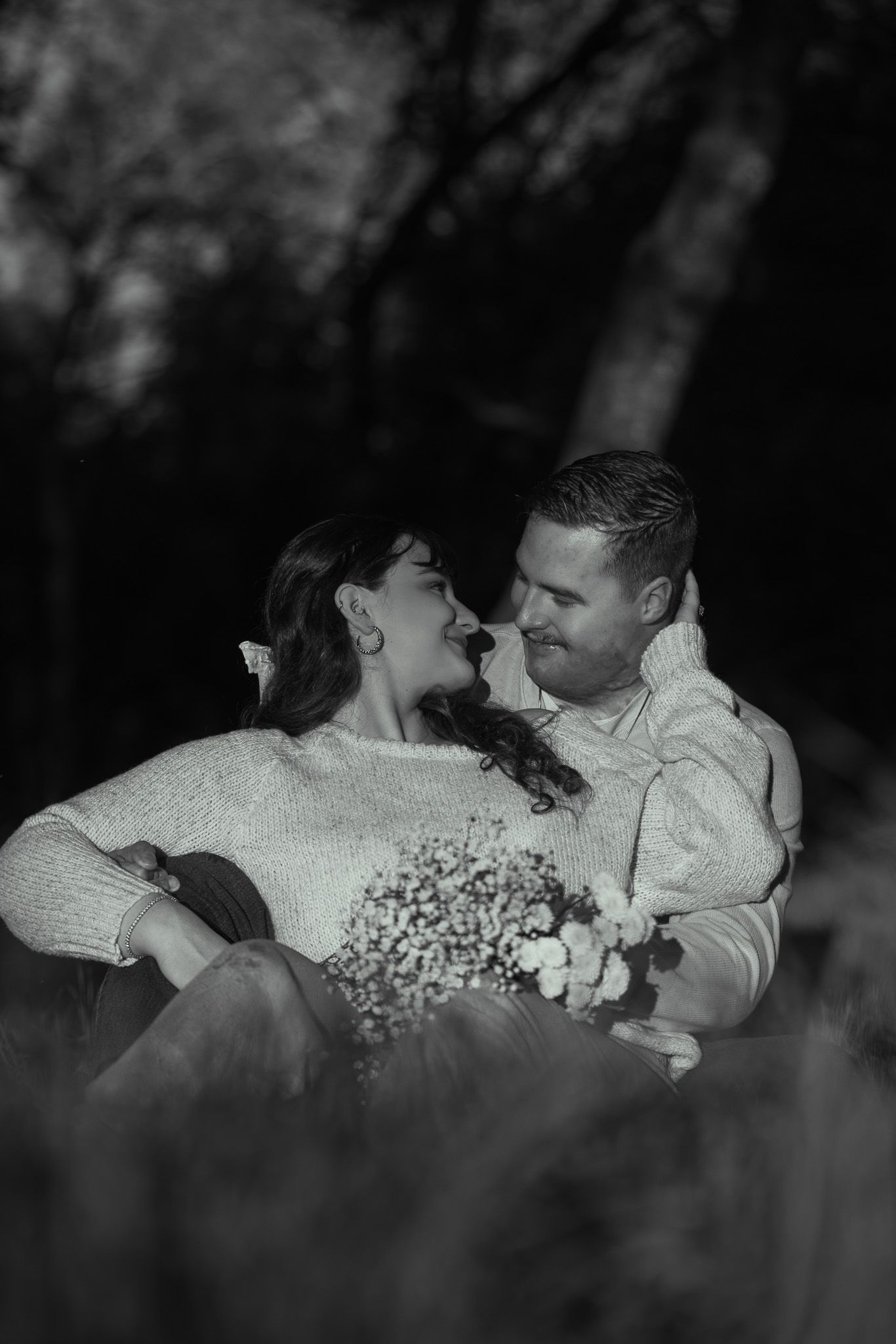 A romantic black and white photo sequence shows a couple in white clothing dancing together in a garden setting.