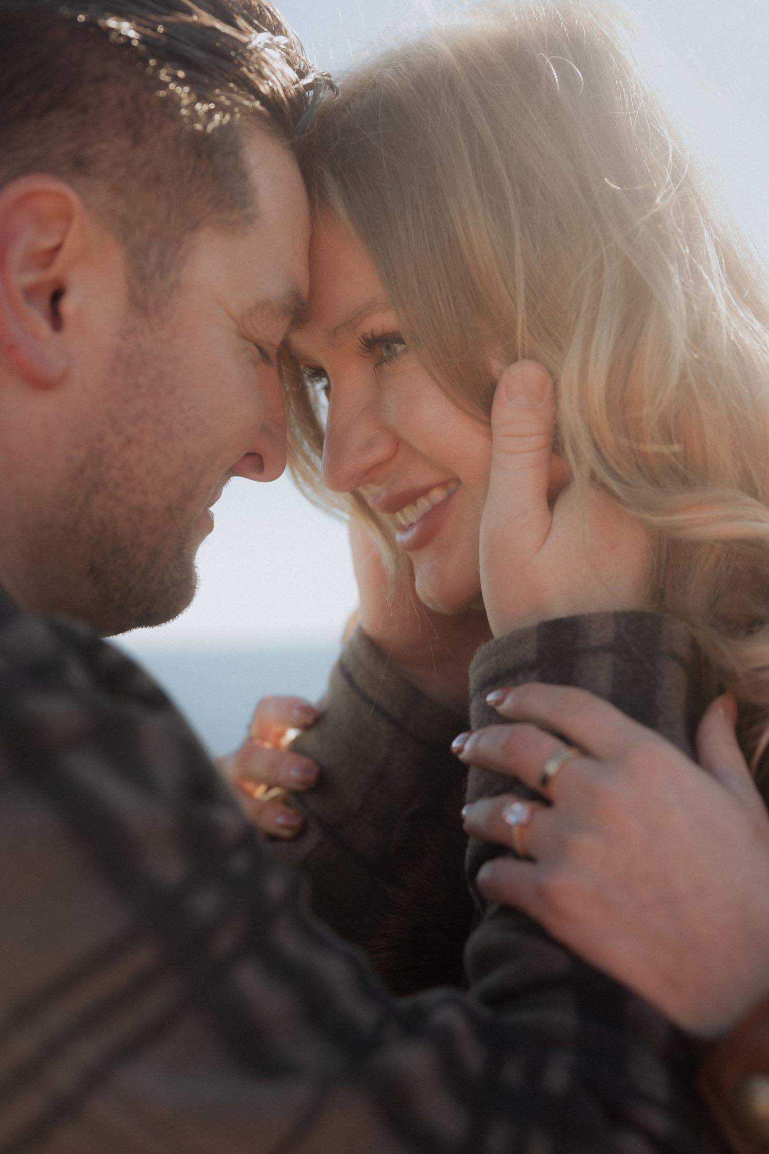 A series of intimate close-up shots showing a tender romantic moment in warm sunlight.
