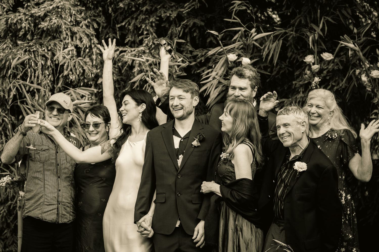 Black and white photo sequence of wedding guests celebrating at a reception.