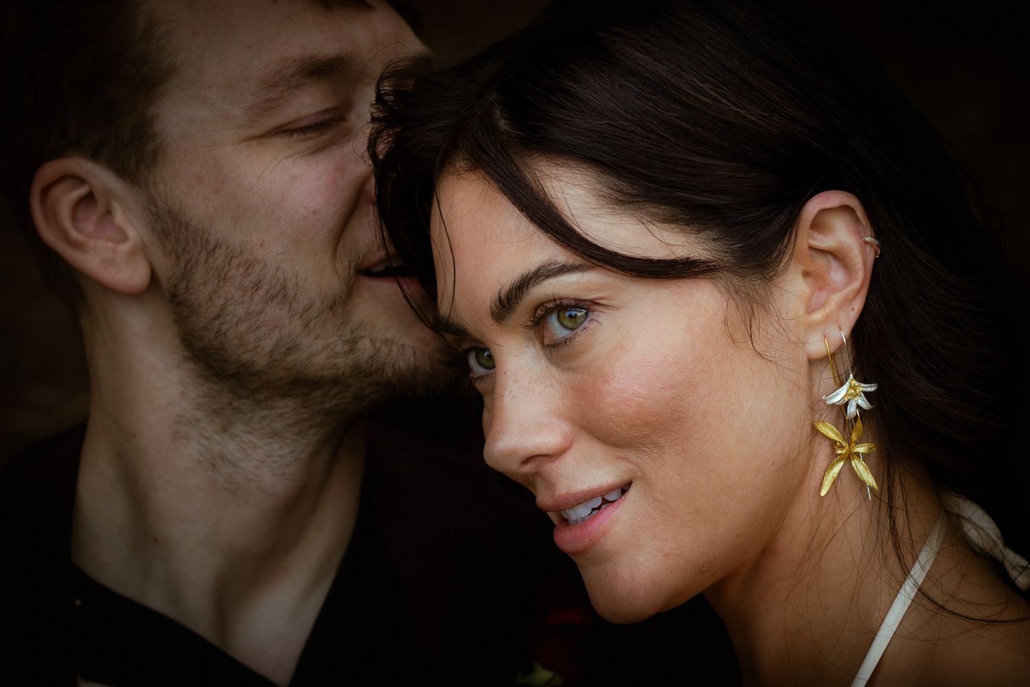 An intimate close-up portrait of newlyweds sharing a tender moment.