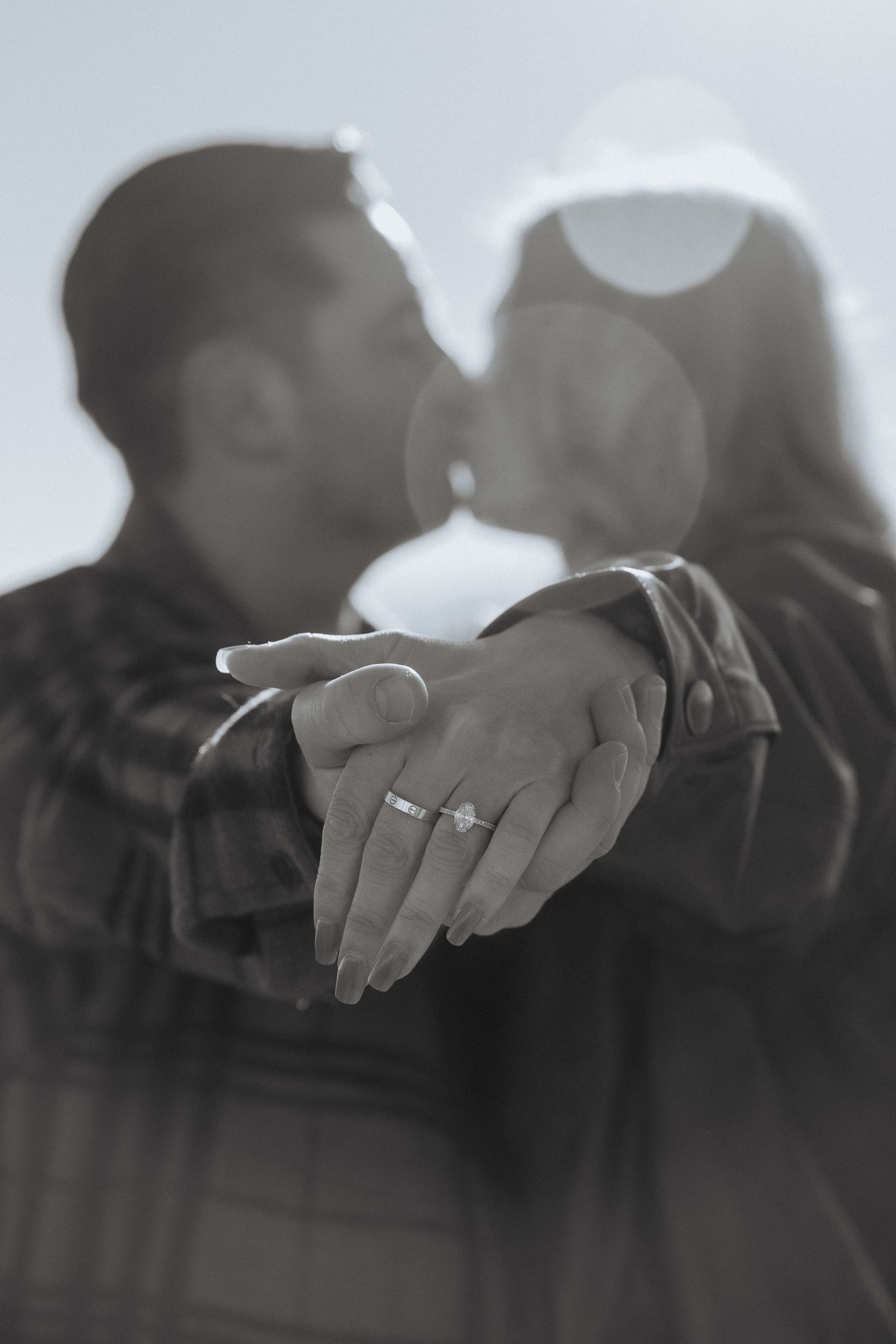 A black and white artistic photo series showing close-up shots of hands in different positions against a blurred background.