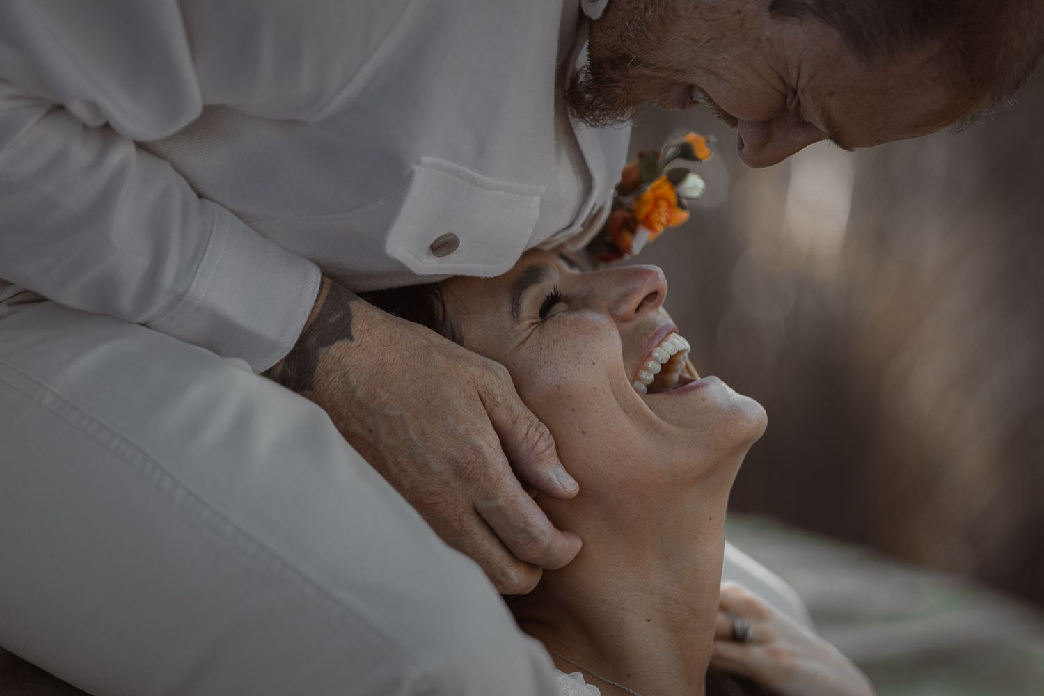 Hands exchanging rings during intimate ceremony.