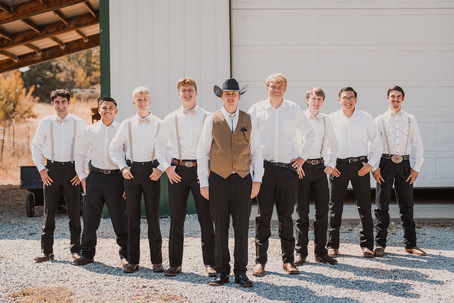 Wedding party members lined up showing their formal black pants and shoes.