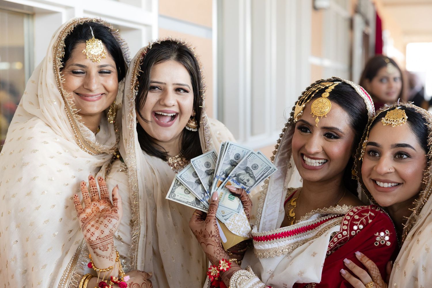Wedding celebration with traditional South Asian attire and decorative elements in bright colors.
