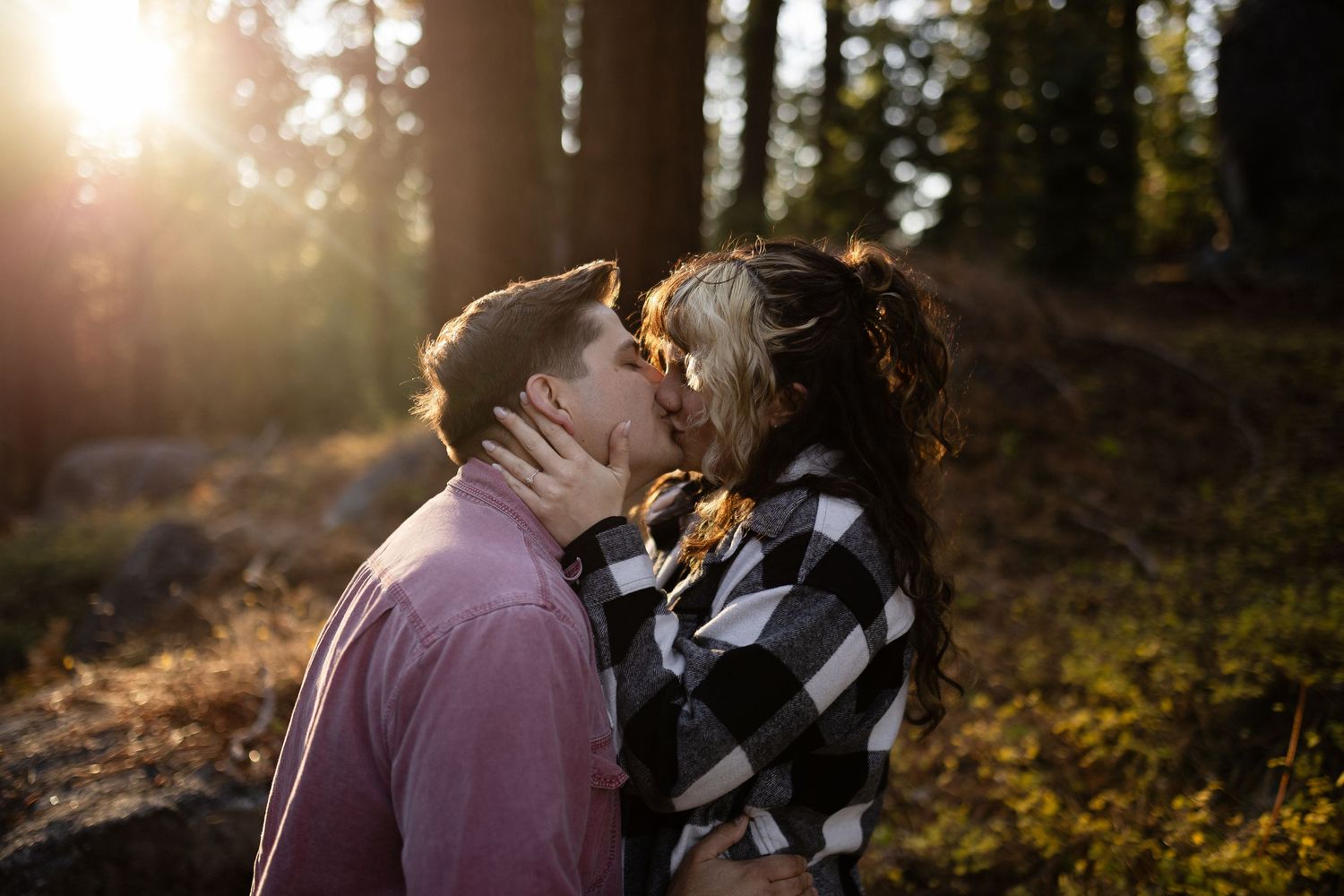 Intimate forest photoshoot with warm backlighting and natural woodland scenery.