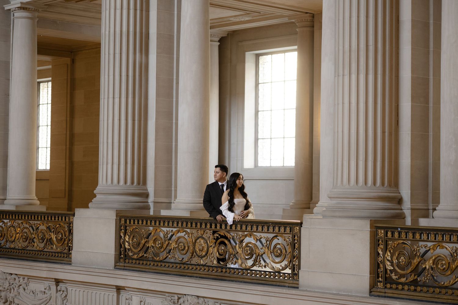 Elegant white marble columns and ornate architectural details in a grand historic building interior.