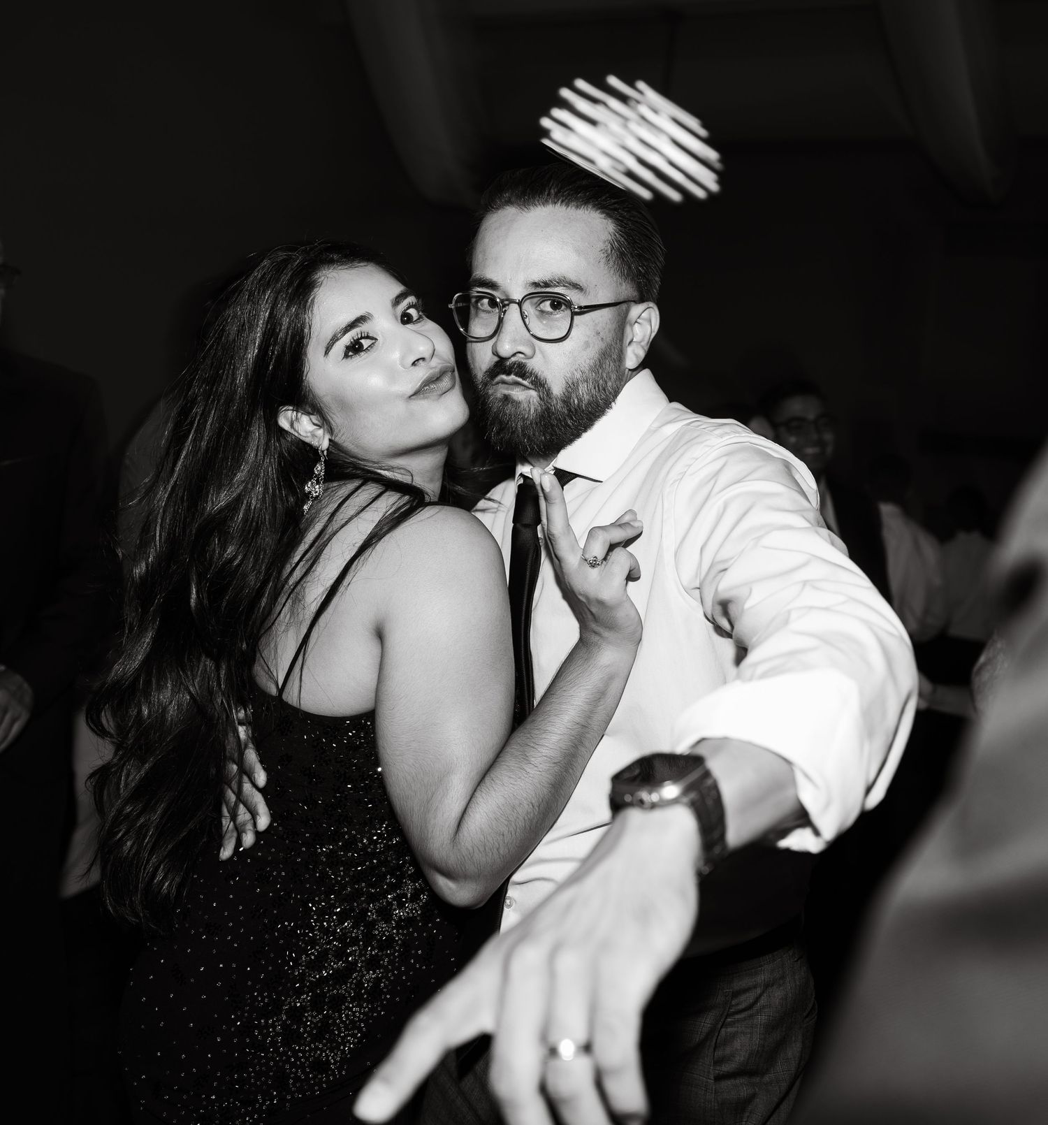 Couples dancing closely during a romantic moment at an evening celebration.