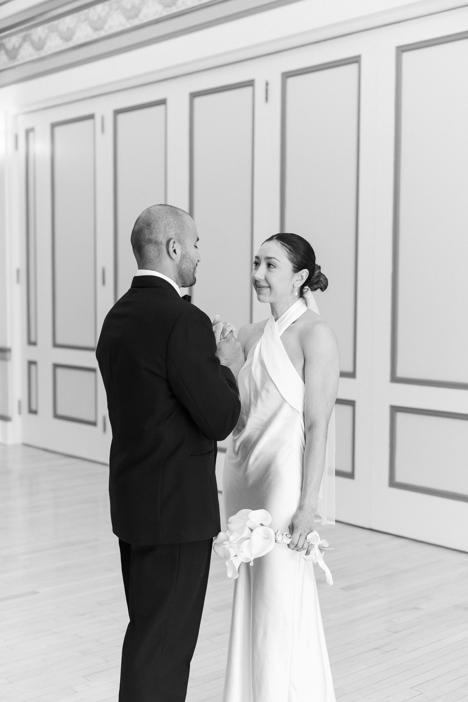Black and white wedding photo series showing tender moments between a bride in white dress and groom in dark suit.