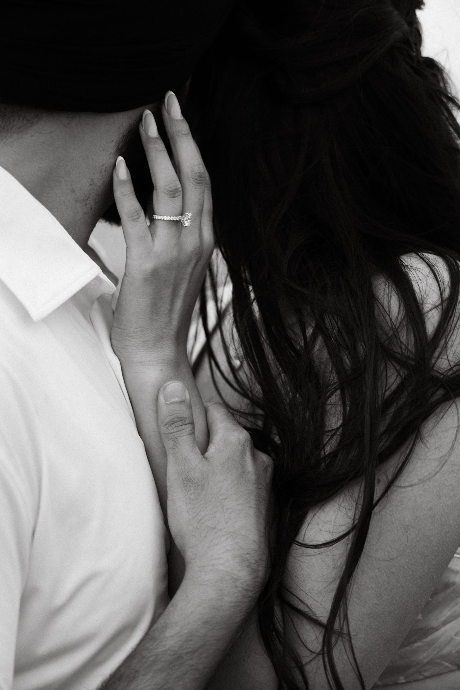 Intimate black and white portraits showing gentle hand placement and tender moments.