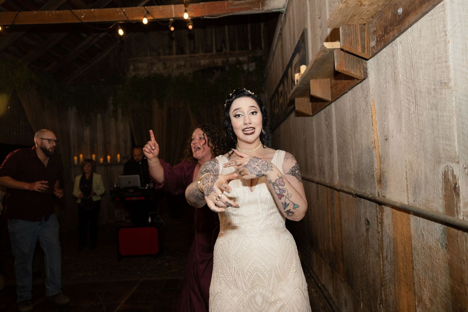 Celebratory dance moments captured in a beautifully lit rustic barn setting.