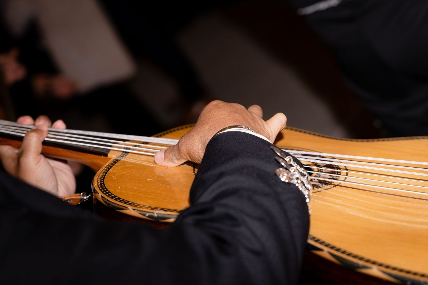 Close-up shot of a violin being played at an elegant event.