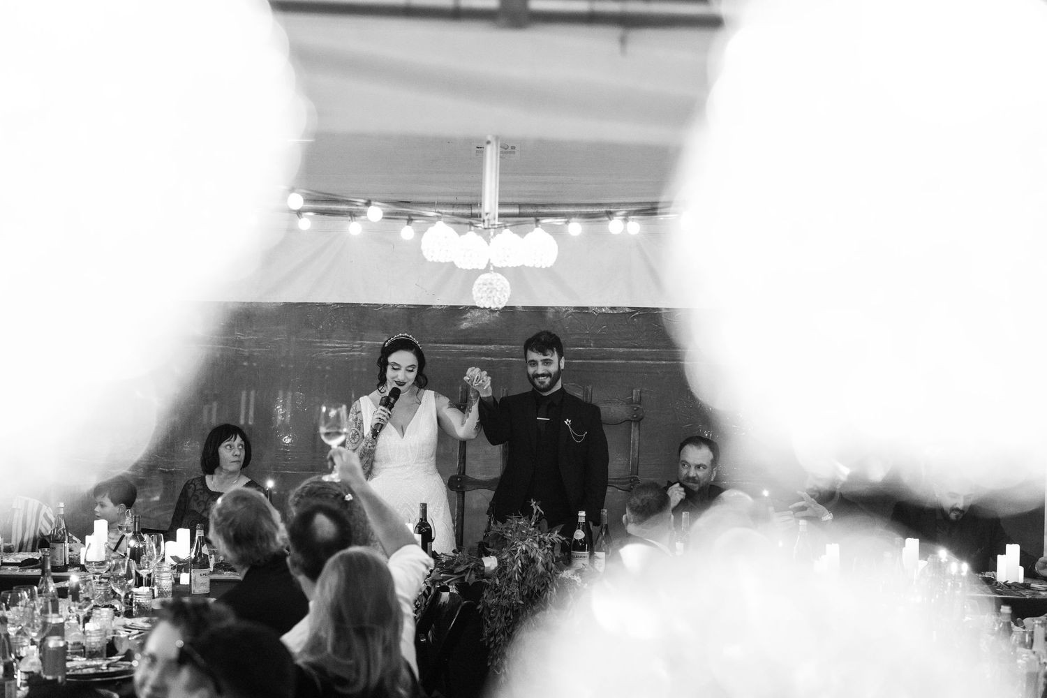 Blurred black and white photo of reception venue interior.