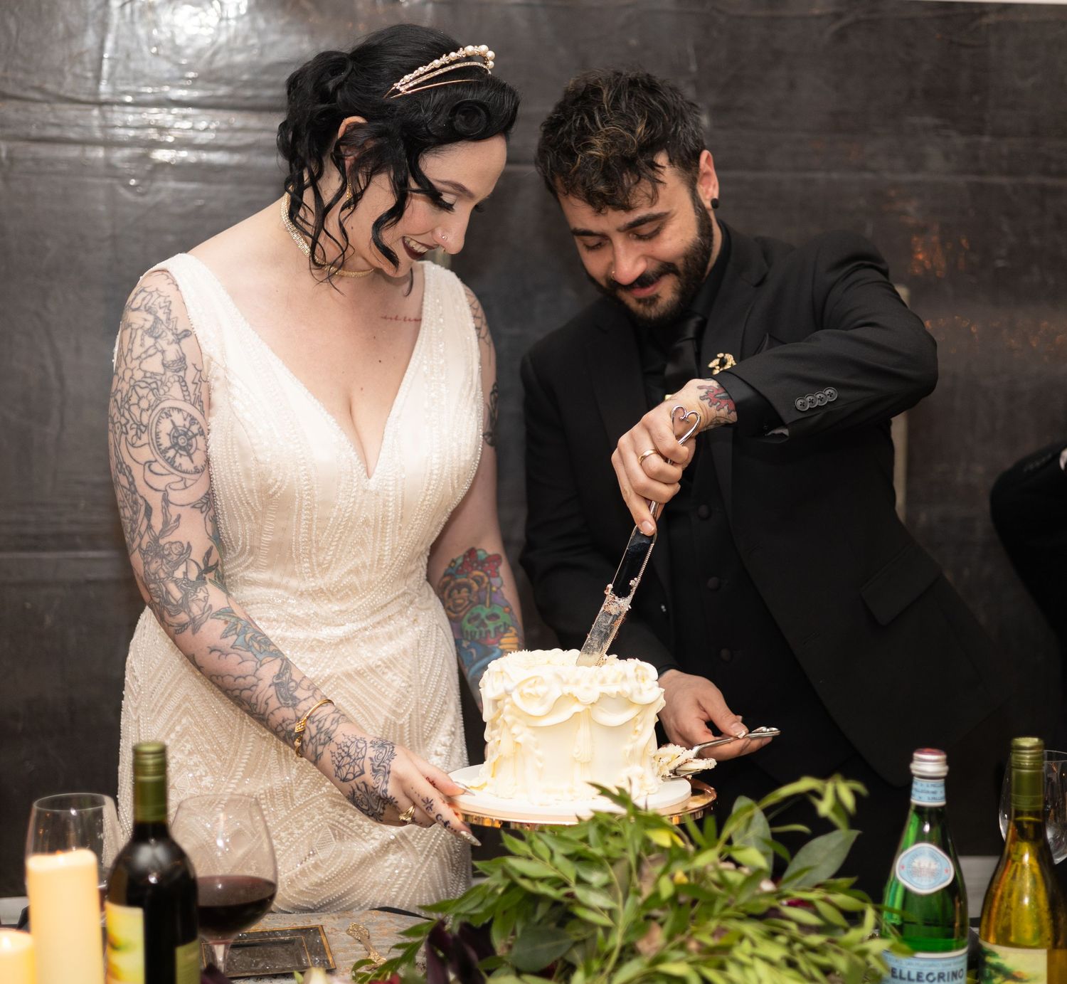 Wedding couple feeds each other cake during their reception celebration.