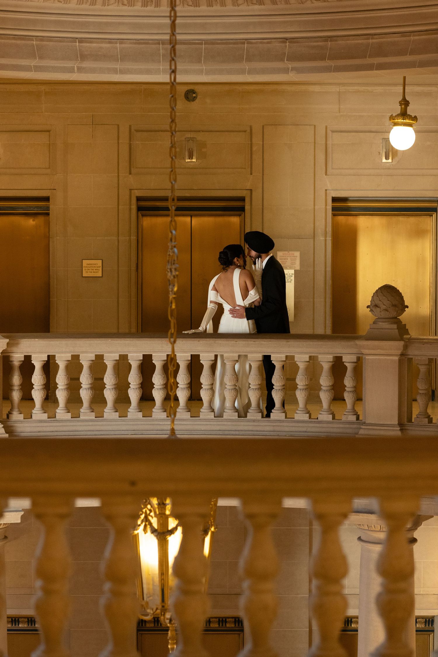 Romantic wedding photography session in a grand historic building with ornate balustrades.