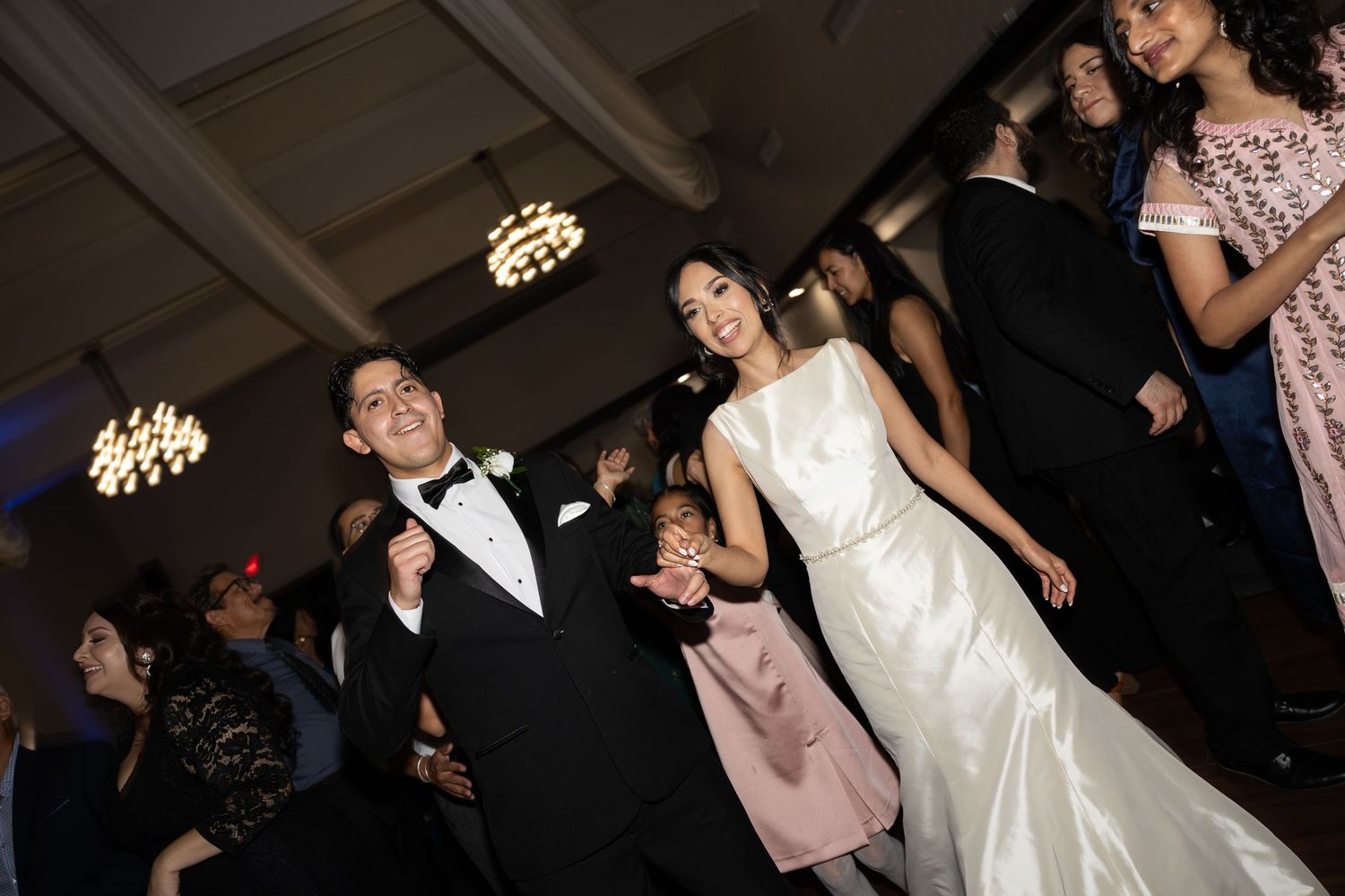 Wedding reception dance floor filled with guests enjoying the celebration.