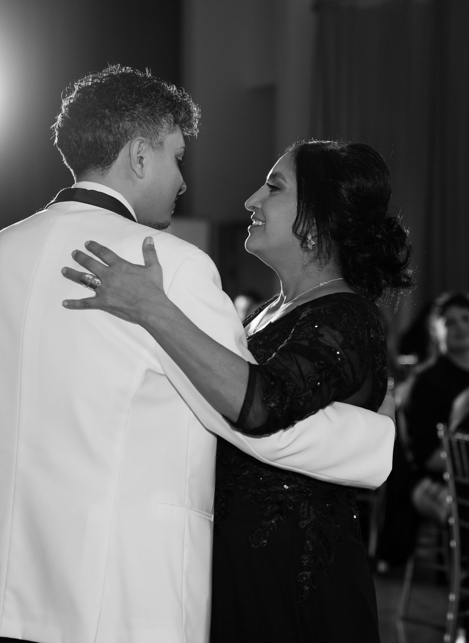 Black and white photo captures intimate dance moment between wedding couple.