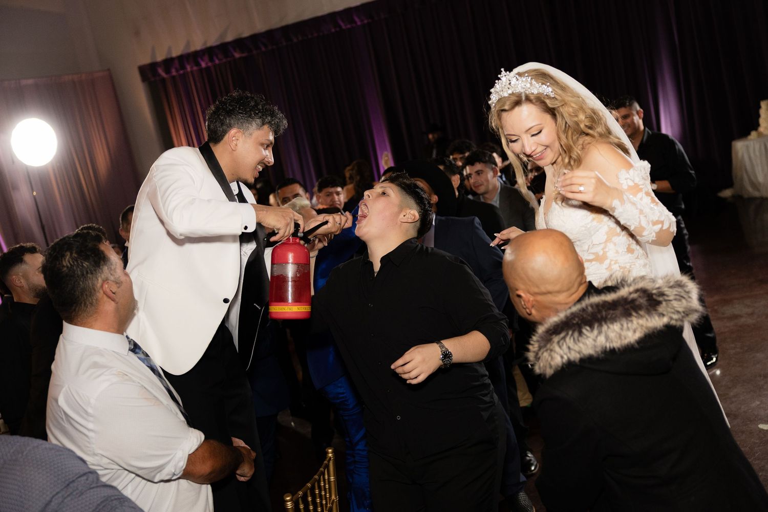 Wedding guests enjoy an energetic dance floor moment during the reception celebration.