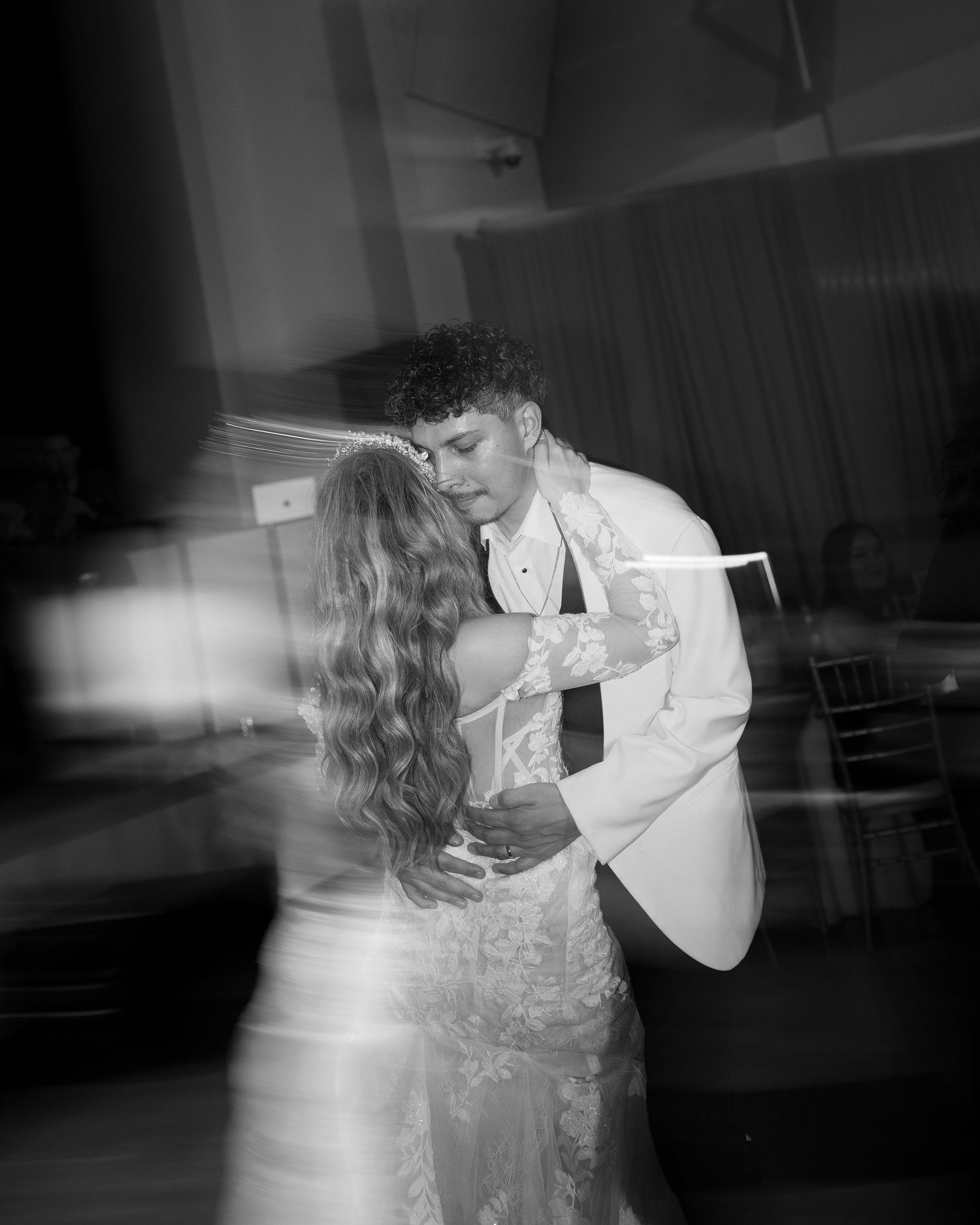 Black and white photos show a couple's first dance at their wedding reception.
