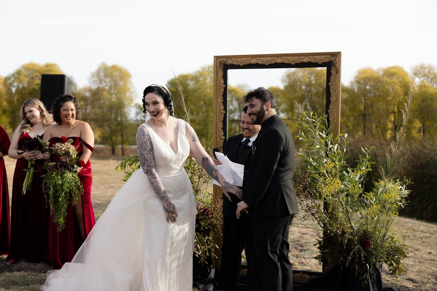 Wedding guests seated in rows at an outdoor ceremony with desert scenery in the background.