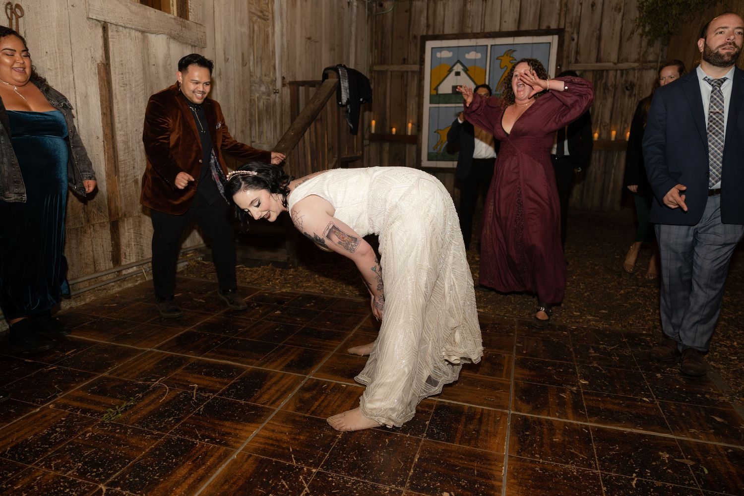 Guests enjoying a lively dance party at a rustic barn wedding reception.