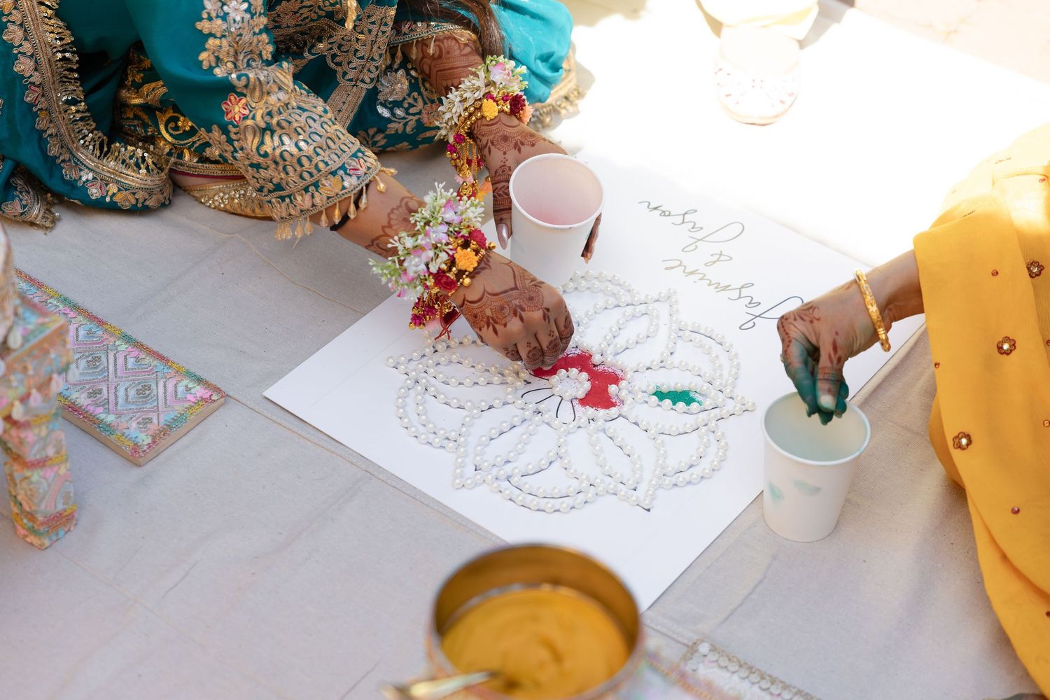 Children color and draw with markers and art supplies on large sheets of paper at a creative activity table.